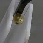 Close-up of brass mounting cap with ventilation holes on the chandelier frame