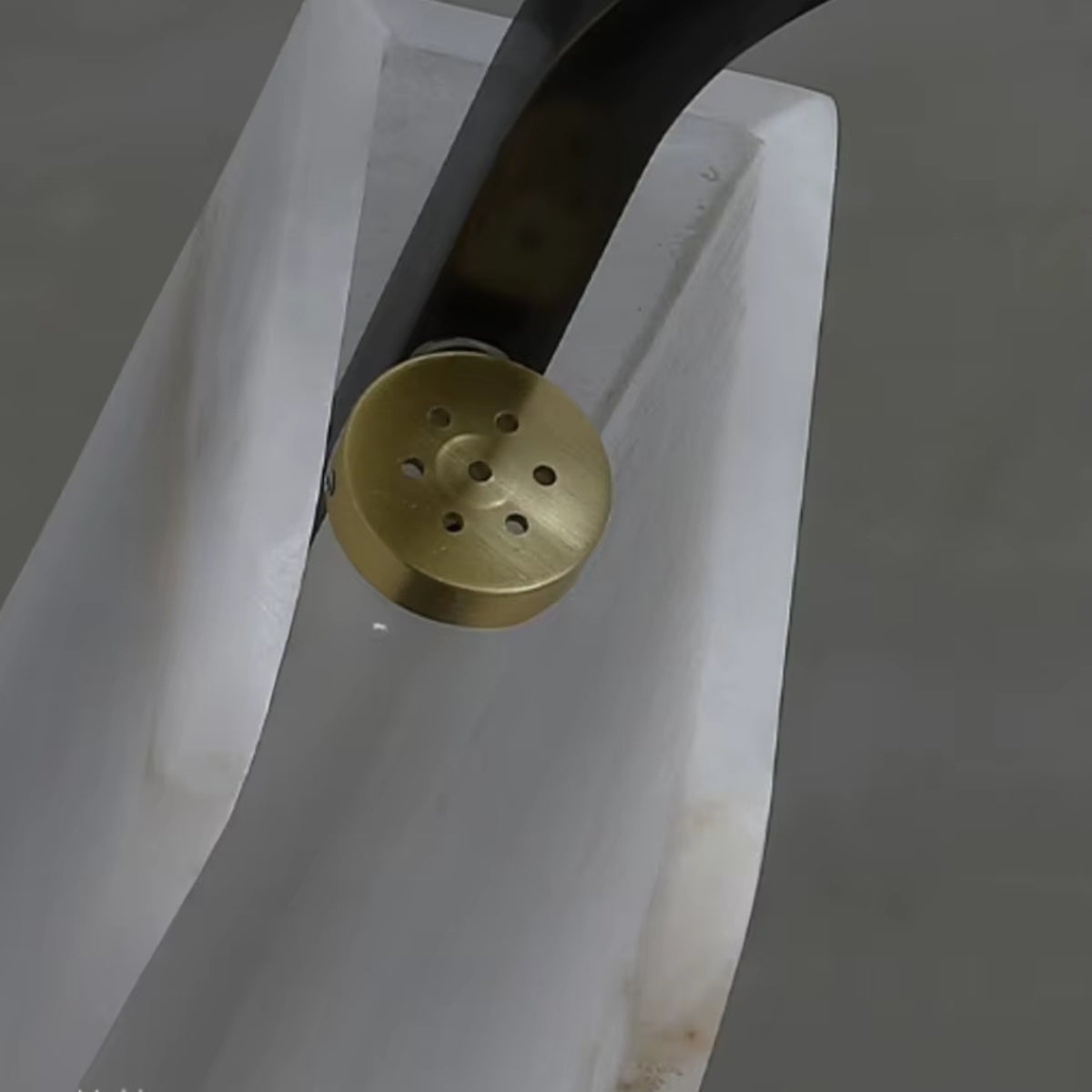 Close-up of brass mounting cap with ventilation holes on the chandelier frame