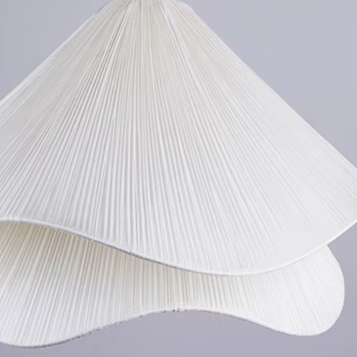 Off-white pleated fabric petal shade detail for a flower pendant light