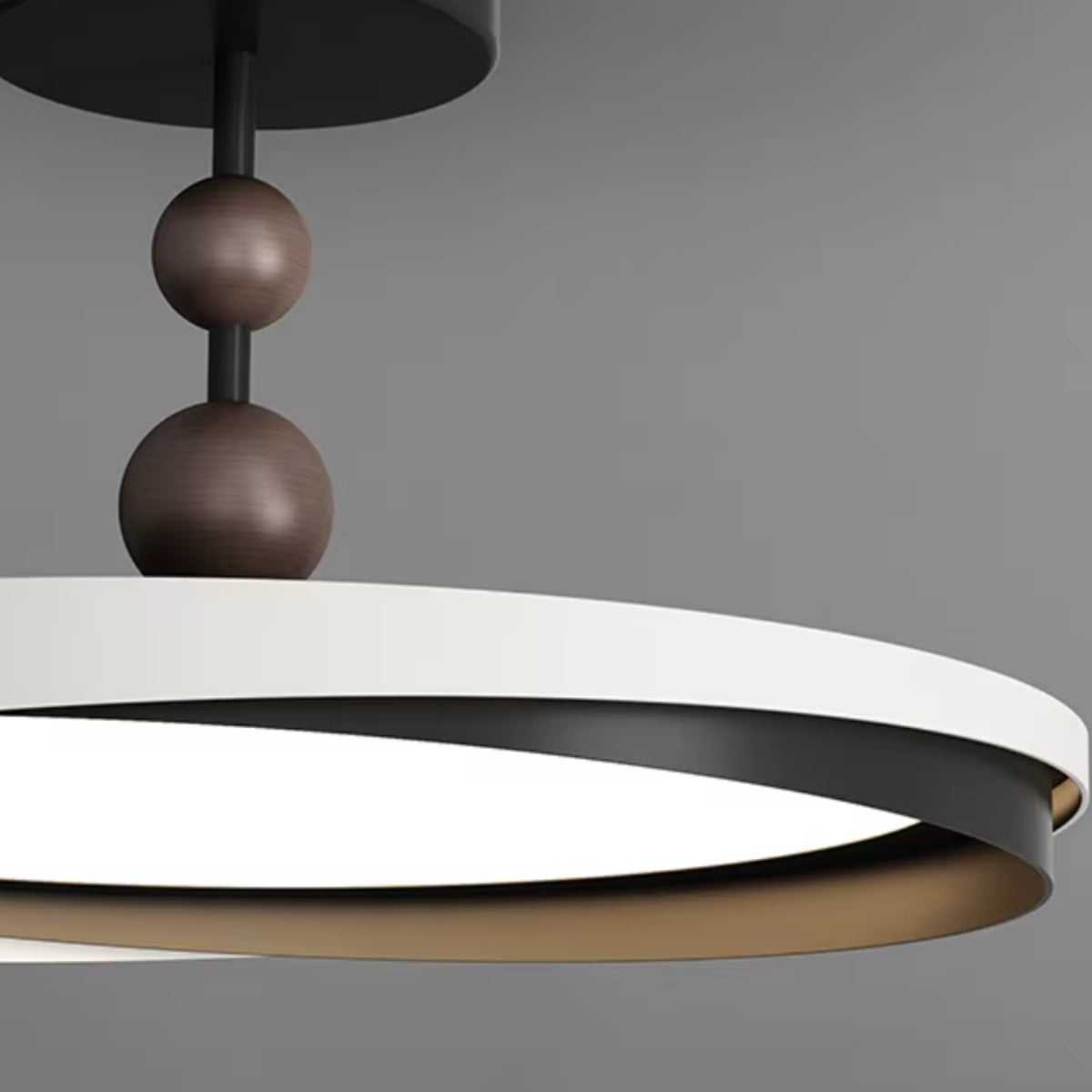 Close view of ceiling light ring shade with dark brown spheres and black central rod