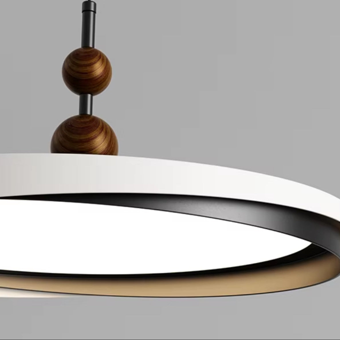 Close-up of ring LED pendant disc shade with dark inner ring and stacked wooden bead connector