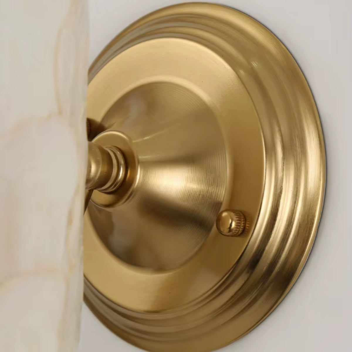 Gold round wall mount with curved arm attachment for capiz shell wall light