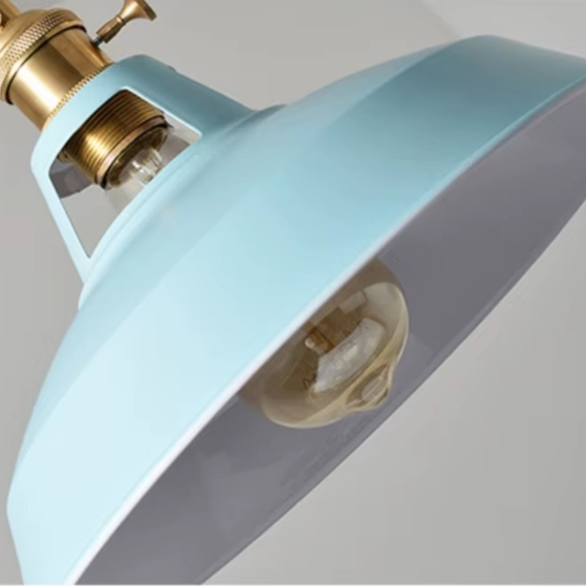 Vintage barn pendant light close-up with light blue metal shade and brass socket