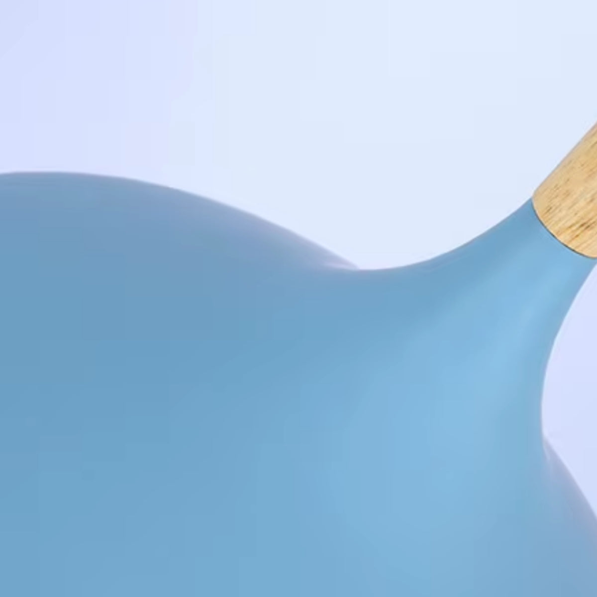 Close-up of a blue dome flared pendant light shade and wood cord cap