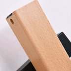 Close-up of light wood arm end with cutout and black internal mounting piece
