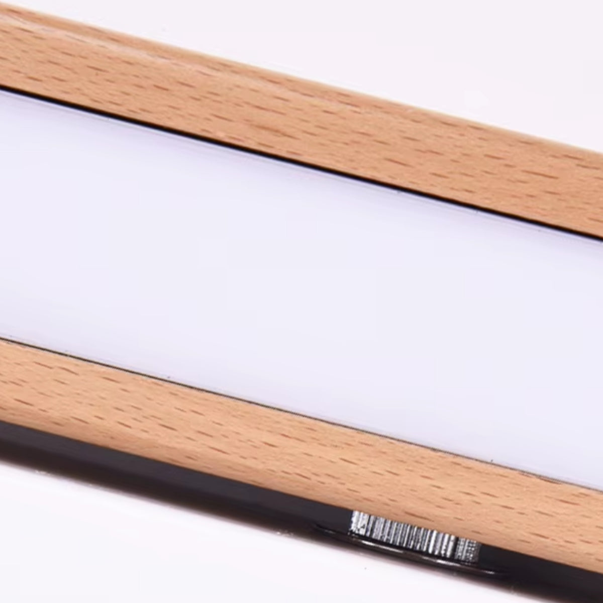 Close-up of horizontal LED tube inside light wood arm for wall light