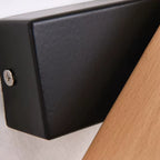 Black square wall mount detail with screw and wood arm connection for wall light