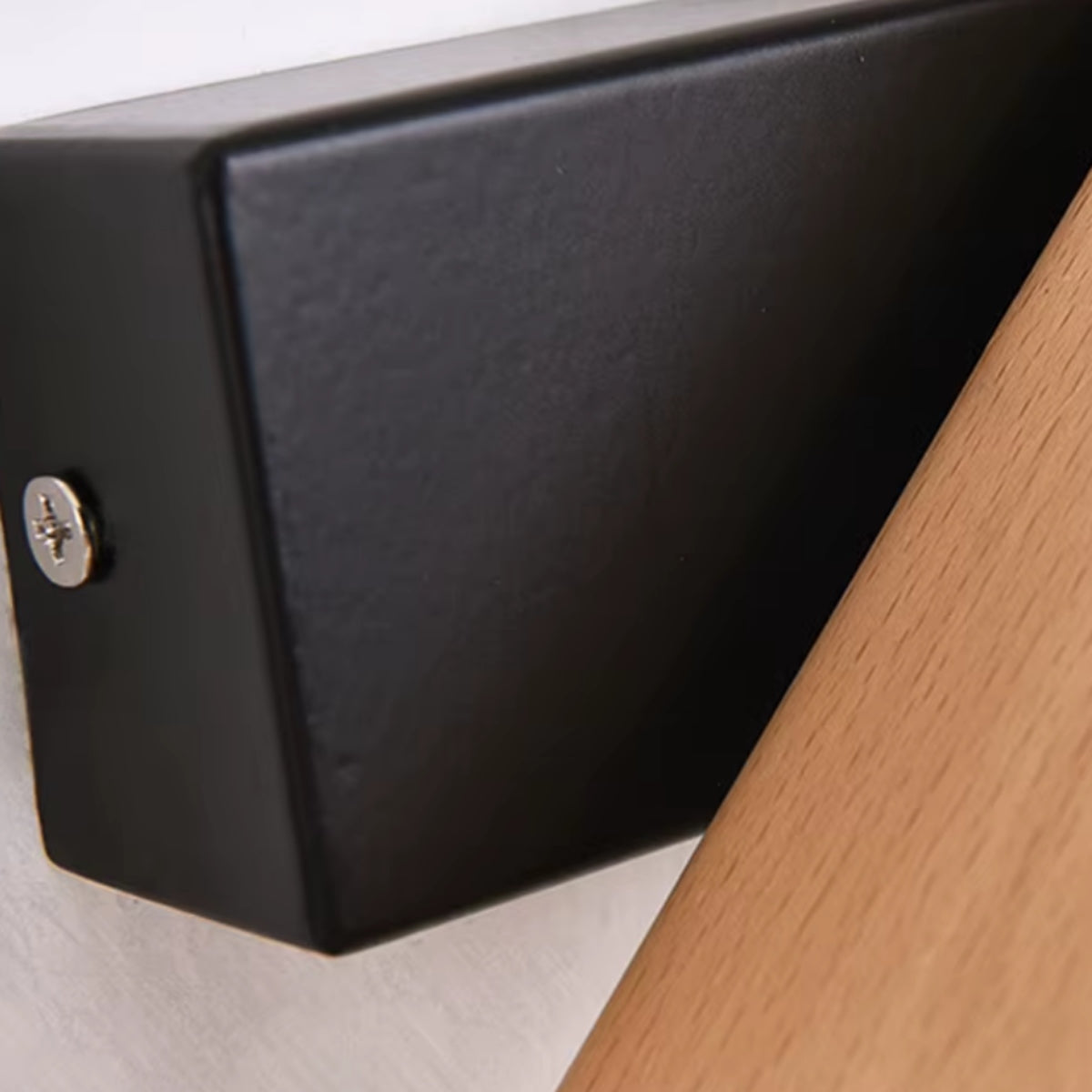 Black square wall mount detail with screw and wood arm connection for wall light