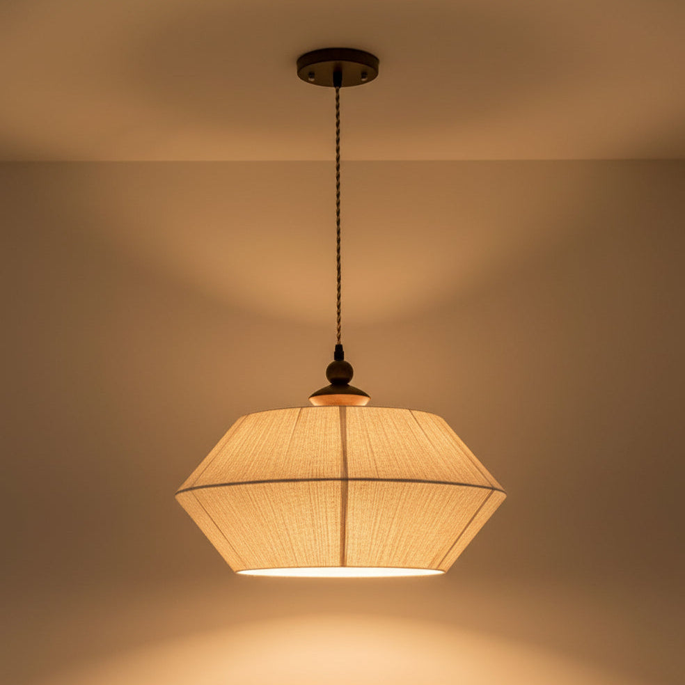 Hexagonal wood pendant drum light with braided cord and warm illuminated shade