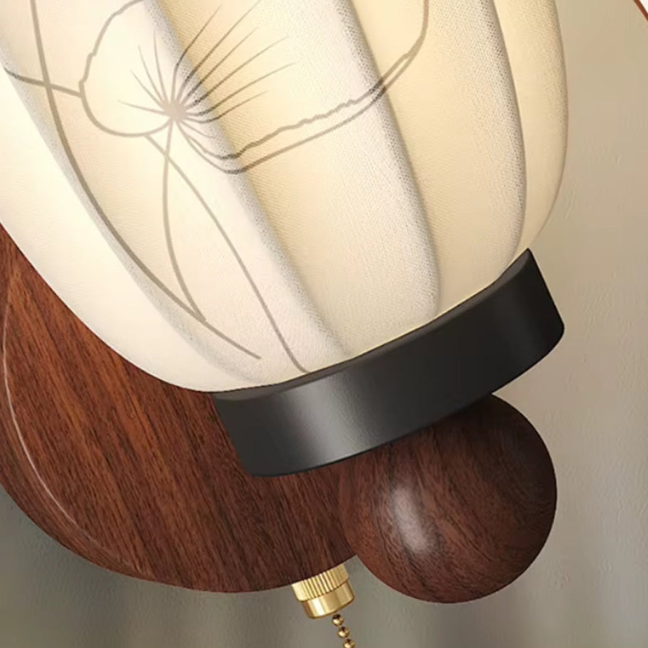 Wall light with frosted white cone shade, black mount, brass stem