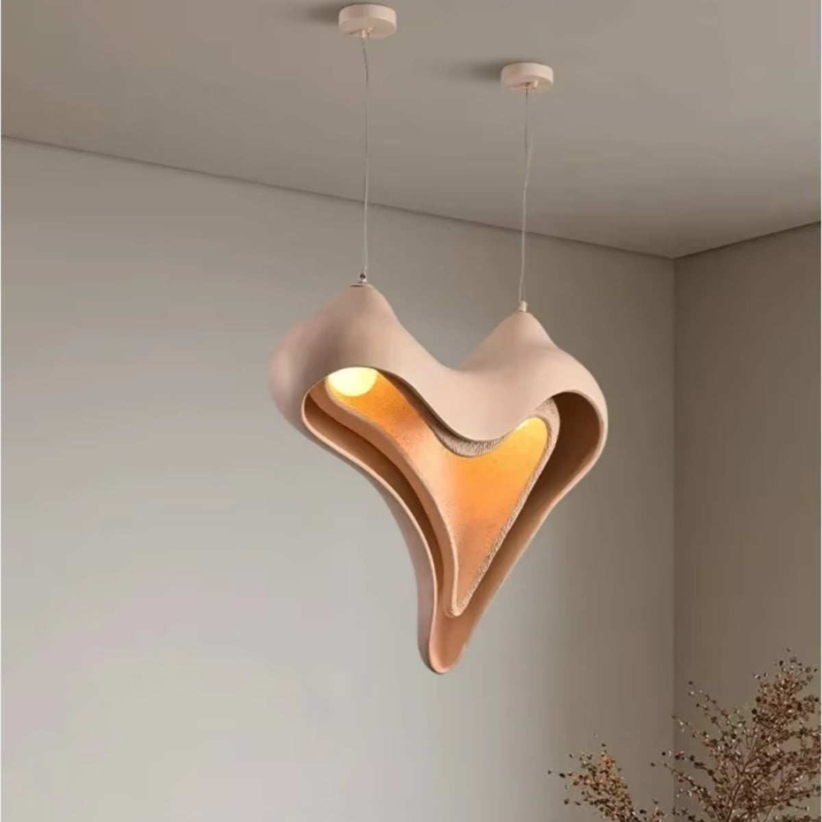 Layered heart conch pendant light hanging from ceiling with warm inner glow