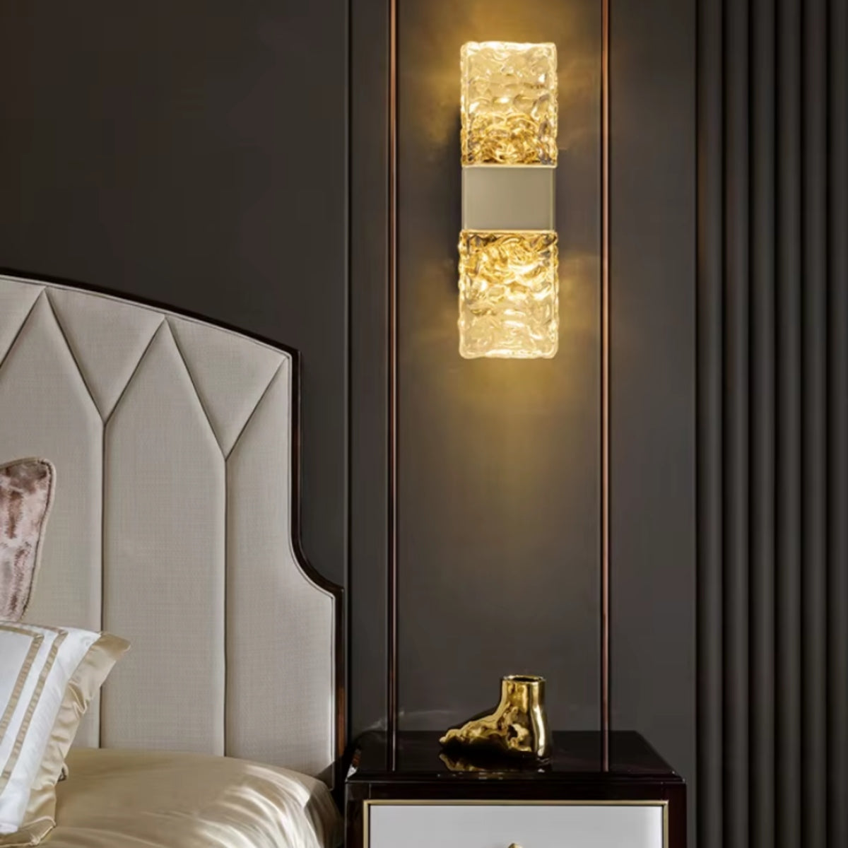Rectangular wall light with stacked textured water-ripple glass panels on wall.