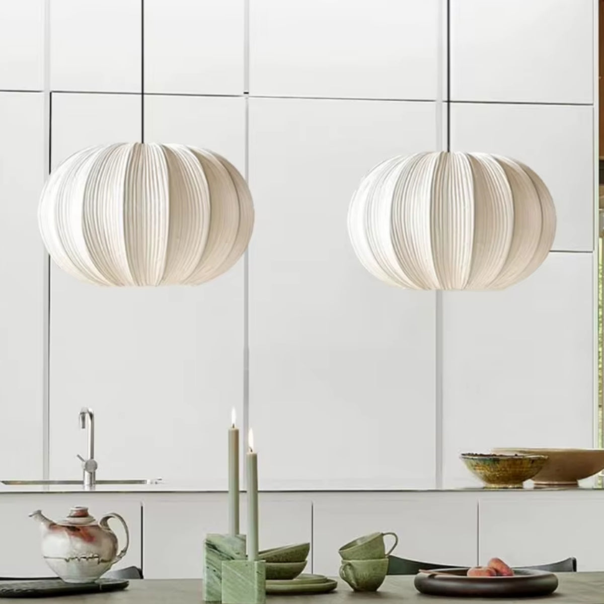 Pair of fabric pumpkin pendant lights with ribbed white shades on cords