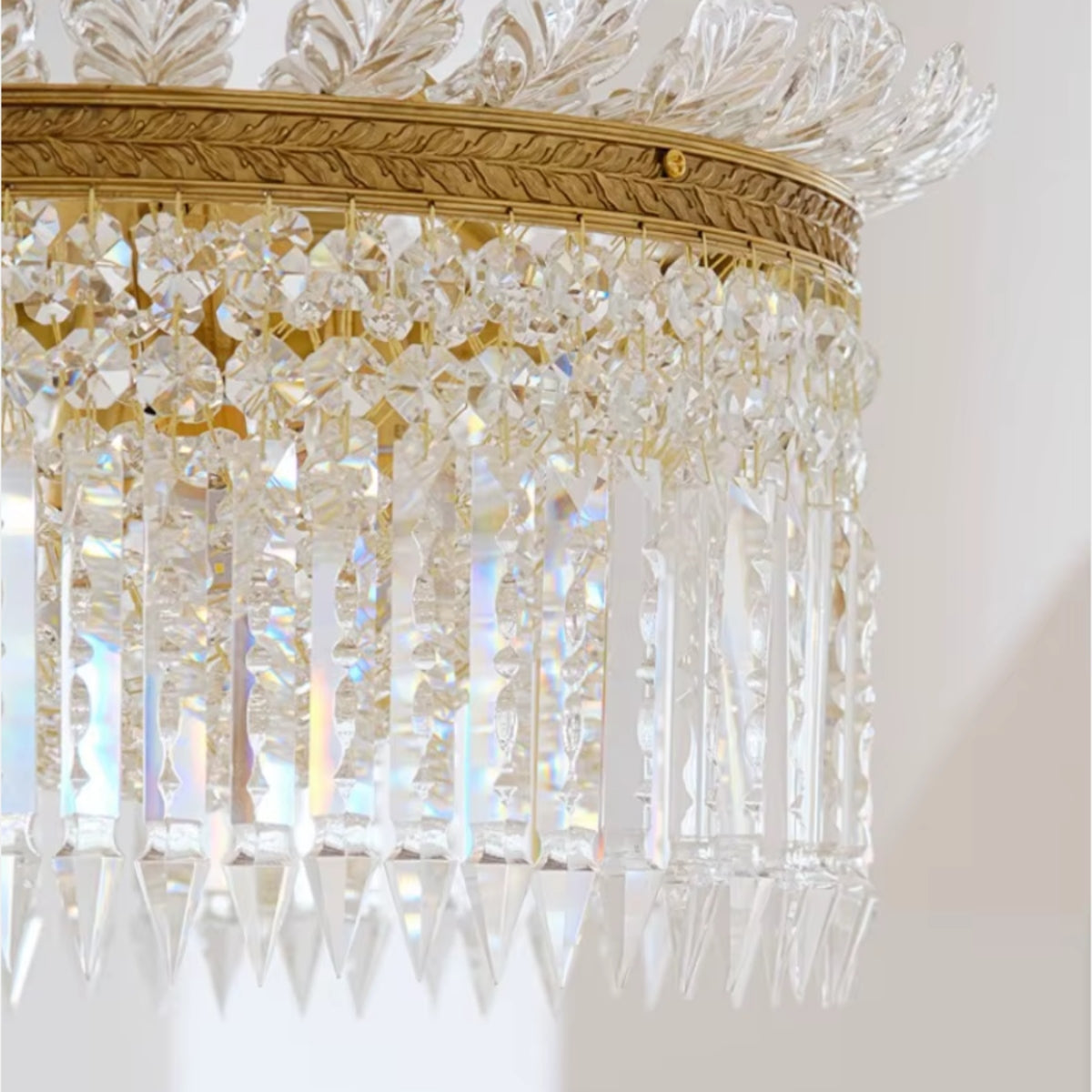 Close-up of crystal prism drum shade on a gold tiered hanging chandelier