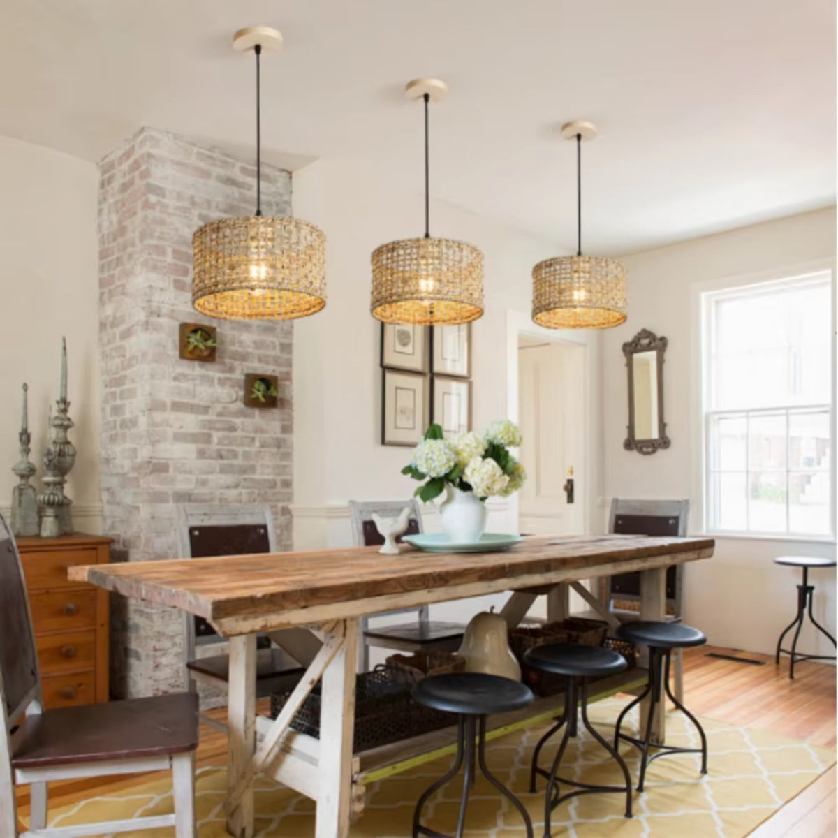 Rattan drum pendant lights with woven shades hanging over a dining table