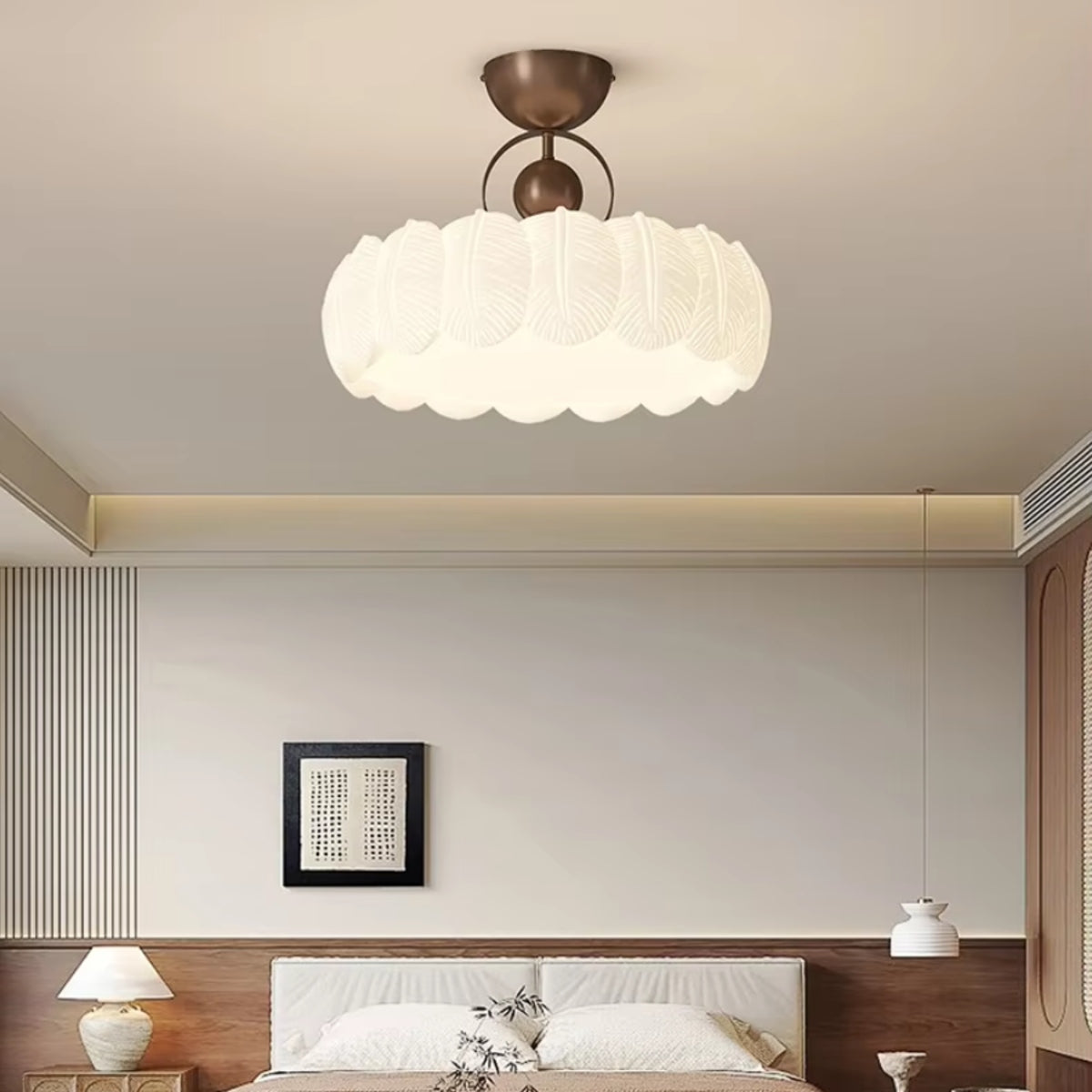 Scalloped petal ceiling light over a bedroom with white layered glass shade and bronze base