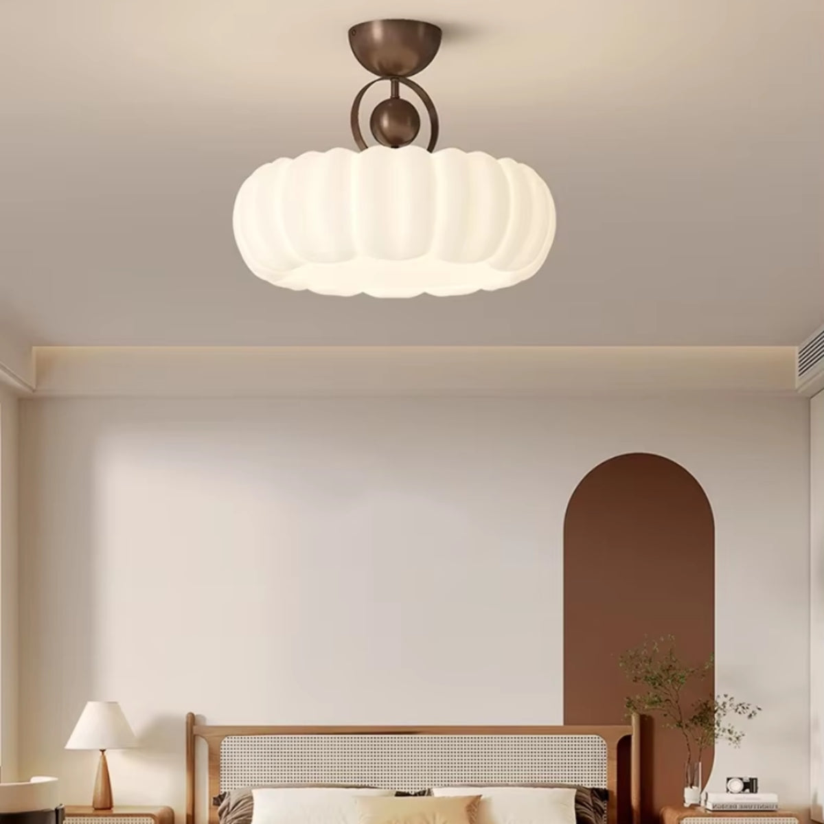 Scalloped petal ceiling light with white cloud shade and bronze mounting in a hallway