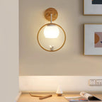 Wood halo bird wall light with lit globe bulb and bird ornament inside circular frame