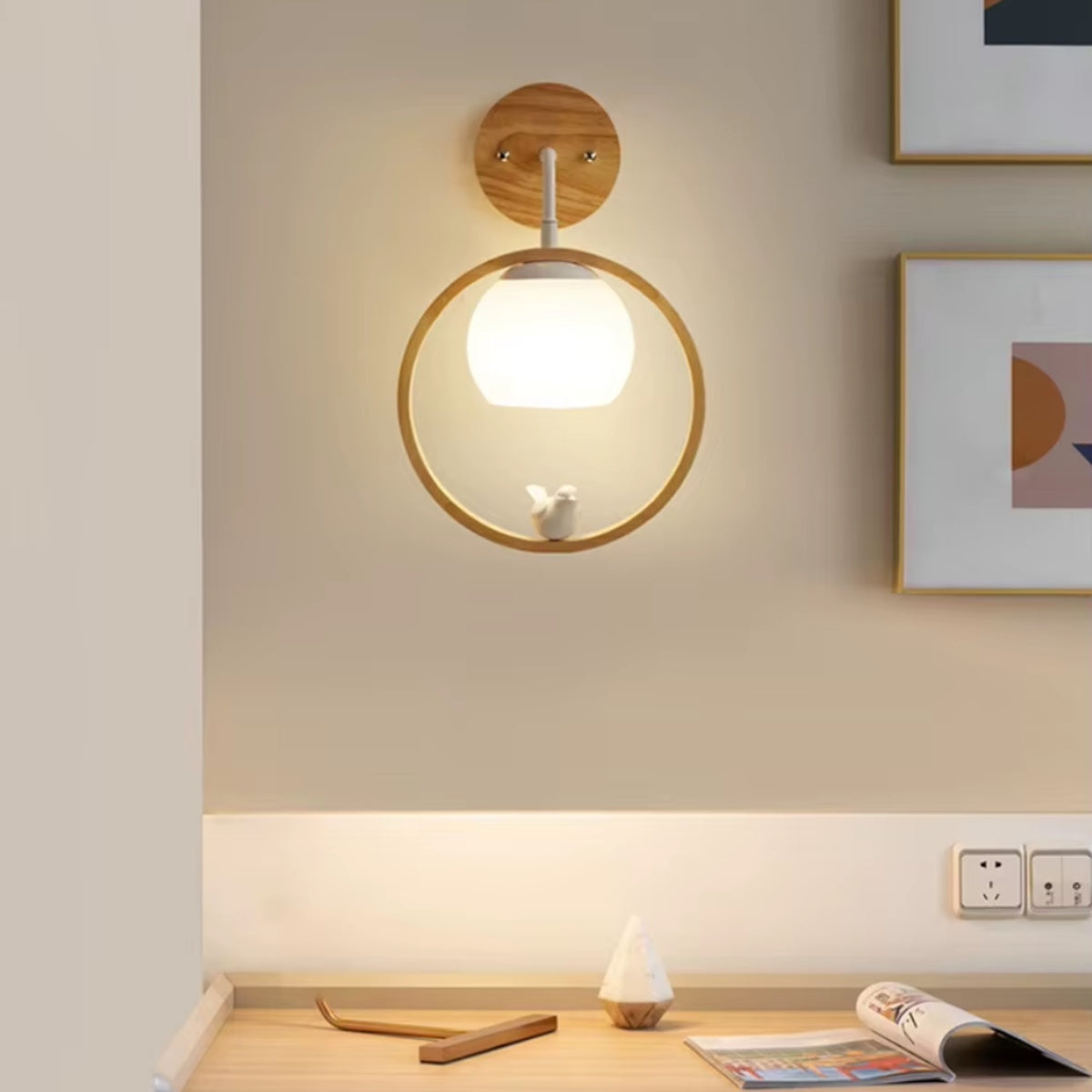 Wood halo bird wall light with lit globe bulb and bird ornament inside circular frame