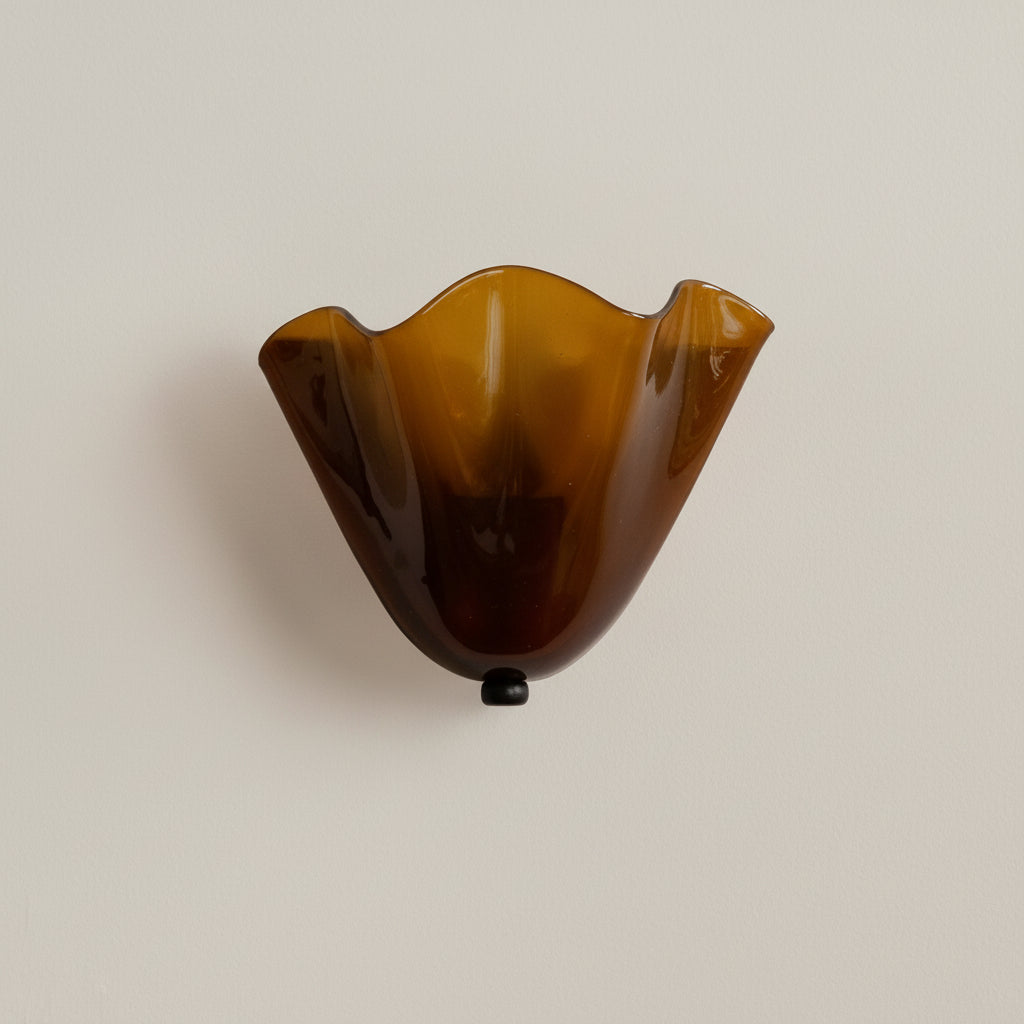 Amber scalloped wave glass wall light with dark mounting base