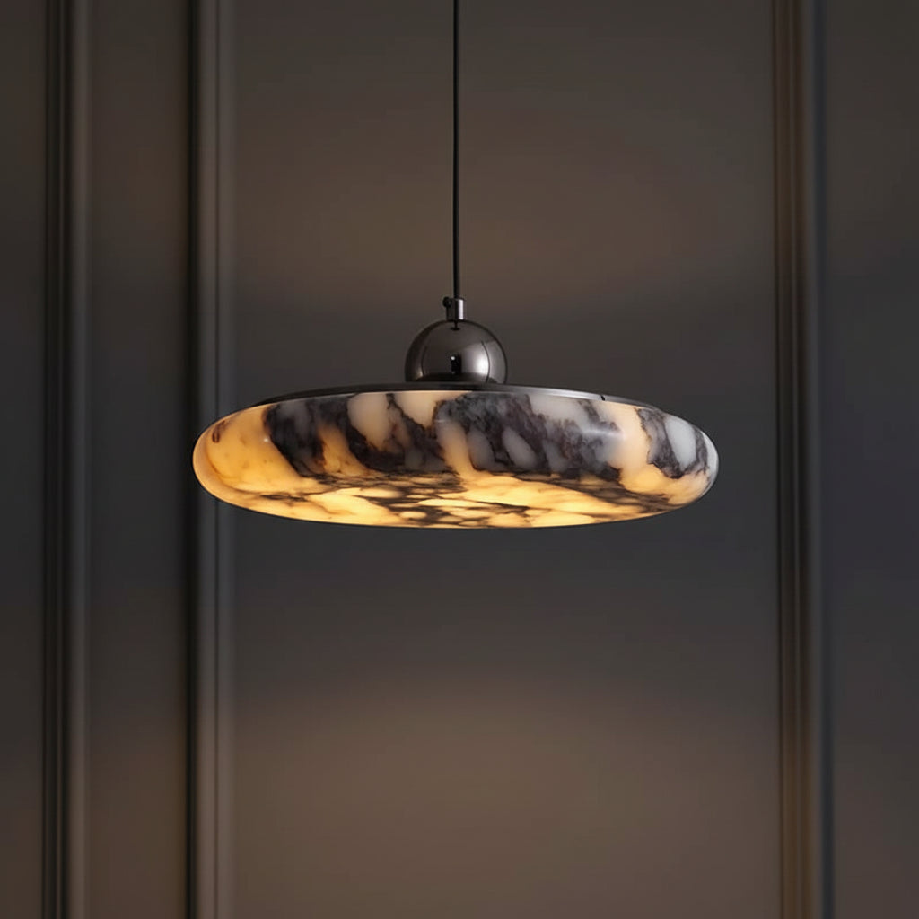Marble pendant light against dark wall; gray-amber veined disc shade with black canopy