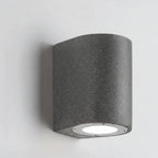 D-shaped wall light with speckled dark-gray housing and round recessed LED