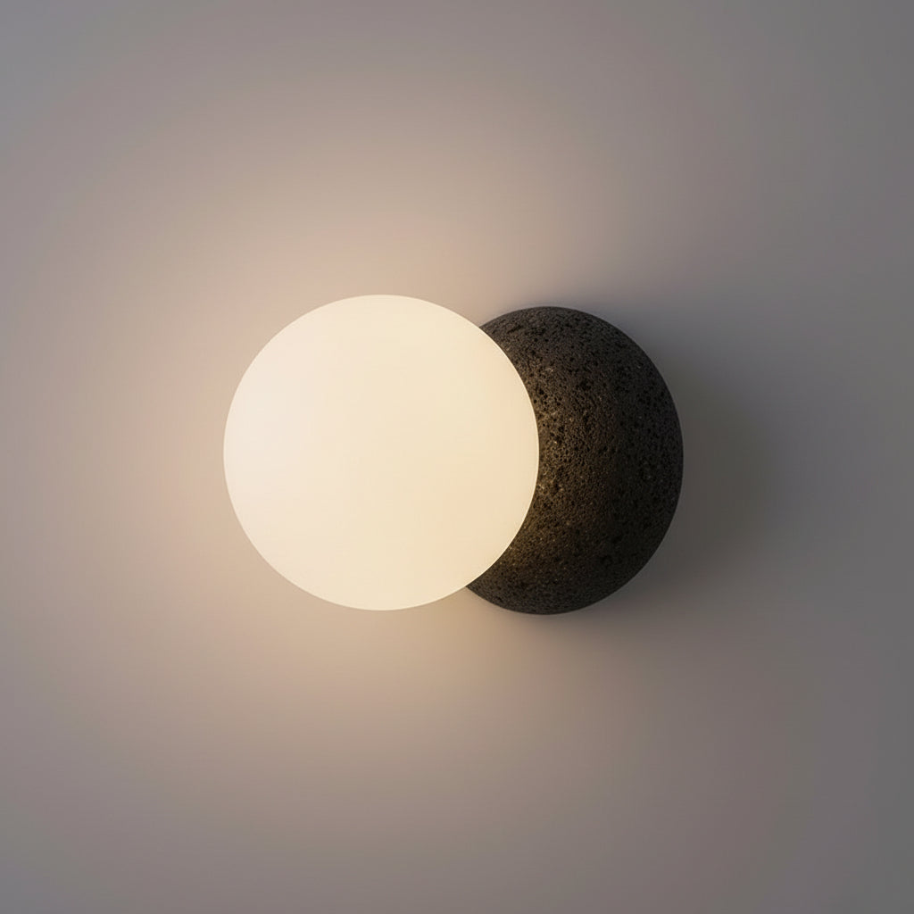 Globe wall light with frosted globe and textured dark concrete wall mount