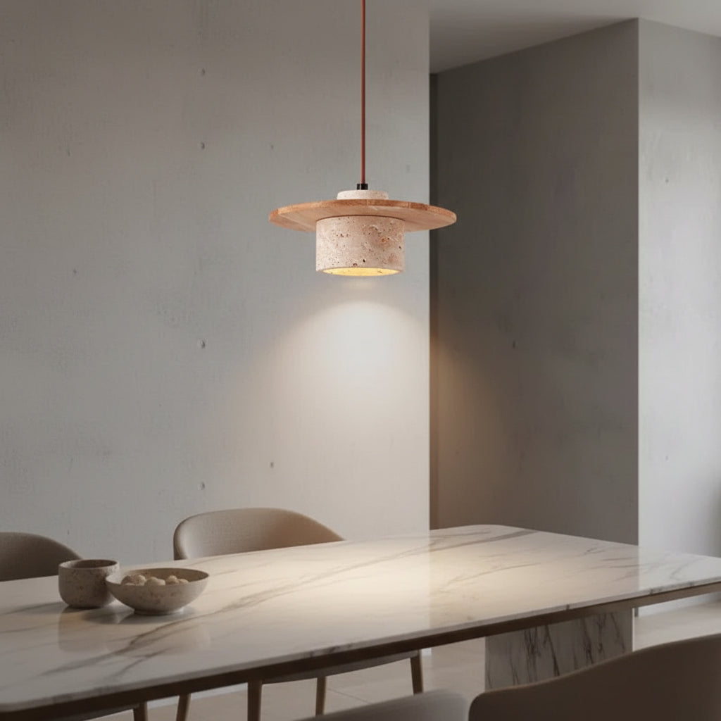 Layered pendant light with travertine-toned shade and warm glowing interior