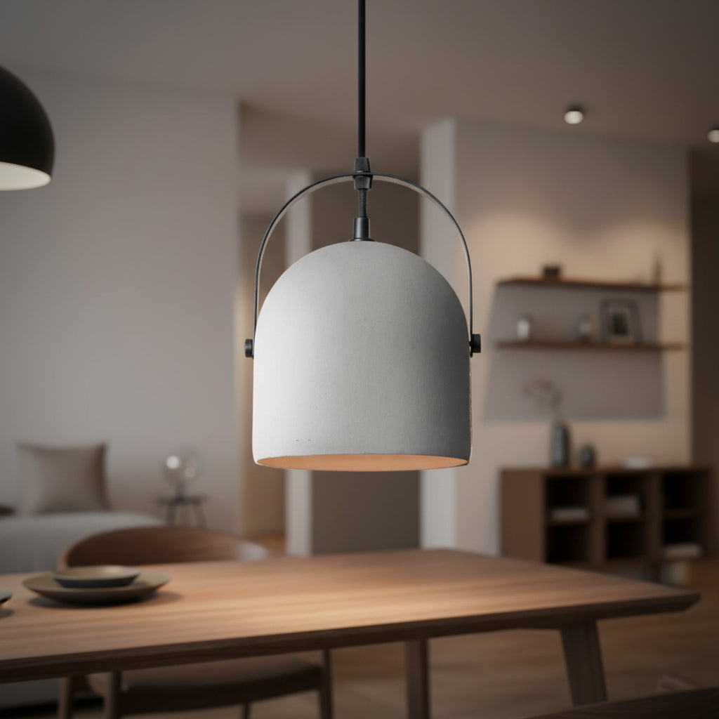 White bell pendant light with black metal arch and warm gold interior.