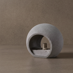 Oval concrete wall light with textured globe shade, niche view of lamp base