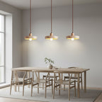 Kivor round travertine pendant light set of three with warm lit bulbs