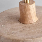 Wooden pendant ceiling mount with slender stem above round travertine shade