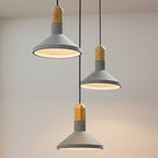 Conical pendant light set with gray metal shades and wood tops on black cords