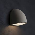 Half-dome wall light, gray curved shade with bright warm underside glow